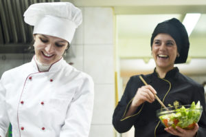 beautiful young chef woman prepare and decorating tasty food in kitchen